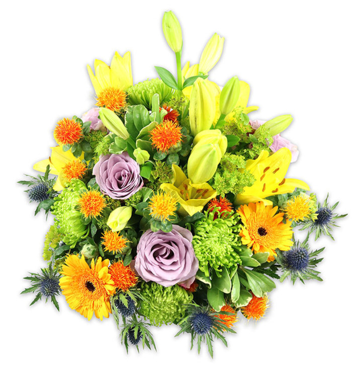 A striking, vigorously textured floral display set against a simple white field, where colour, form and scent are conveyed with clarity. Sunlit yellow Asiatic lilies form the vertical accents: some bloom wide with speckled throats and open faces, others remain as elongated buds in a fresh chartreuse yellow, suggesting anticipation and growth. Nestled amid this upward movement are soft lavender roses whose cool, powdery petals create a peaceful centre and an elegant focal pause. Bright orange Gerbera daisies fan their flat petals like miniature suns across the surface, while tight, lime-green button chrysanthemums produce abundant volume and a ruffled, cushion-like texture. Tiny spherical orange and golden yellow accent flowers-reminiscent of Craspedia or small pom-pom thistles-pepper the composition with lively, tactile dots. Blue-grey Eryngium sea thistles jut from the lower edges and sides, bringing a durable, architectural contrast with their spiky bracts and steel-blue tones. Varied greens-broad lily blades, glossy filler leaves and softer sprigs-form a verdant backdrop that unifies the diverse blooms.

The sensory character is warm and optimistic: the lilies offer a soft, heady perfume that mingles with the roses' gentle scent, while the thistles provide a cool, almost resinous note and a distinctive tactile counterpoint. Suited to celebrations, anniversaries, or to brighten a home or office, this bouquet would sit beautifully on a High Road table in East Finchley or as a thoughtful delivery to neighbours near Fortis Green Road. Its balanced mix of classic blooms and unexpected accents makes it both familiar and modern-comforting, lively and expertly composed.