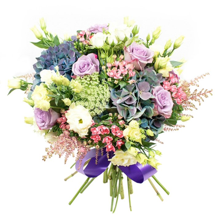 Evoking the tranquil yet cosmopolitan feel of East Finchley, this expertly arranged bouquet is a celebration of colour, texture, and the joys of locally inspired floristry. Set against a white background to allow every nuanced detail to shine, the design features abundant hydrangea heads in shades of deep indigo, teal, and soft purple at its heart. These voluminous clusters create a lush backdrop, reminiscent of the elegant landscaping seen along High Road and nearby Muswell Hill. Nestled among the hydrangeas are roses in shades of lavender, lilac, and classic white, their petals elegantly curled, offering a sense of purity and romantic grace. Ruffled white ranunculus blooms introduce plush fullness, while slender pale yellow eustoma buds stretch through the bouquet, adding height and lightness-a visual tribute to the wild flowers growing near East Finchley's green spaces. Sprays of brilliant fuchsia-pink fillers and delicate, feathery pale pink astilbe add movement, their whimsical textures echoing the creativity of local communities nearby. Lace-like, light green and white filler flowers (such as Ammi Majus) thread through the core, providing intricate, delicate contrast. Dark green leaves gently frame and support the composition, highlighting the vibrancy of each petal. The whole bouquet is carefully gathered and tied with a wide, glossy royal purple satin ribbon, finishing the look with a modern touch of richness. Crafted by skilled hands at East Finchley Flowers and available for prompt local delivery, this arrangement is perfect for celebrations, heartfelt gifts, or adding a sense of luxury to everyday life in N2.